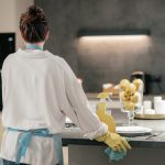 Housework. A woman looking busy while cleaning the kitchen